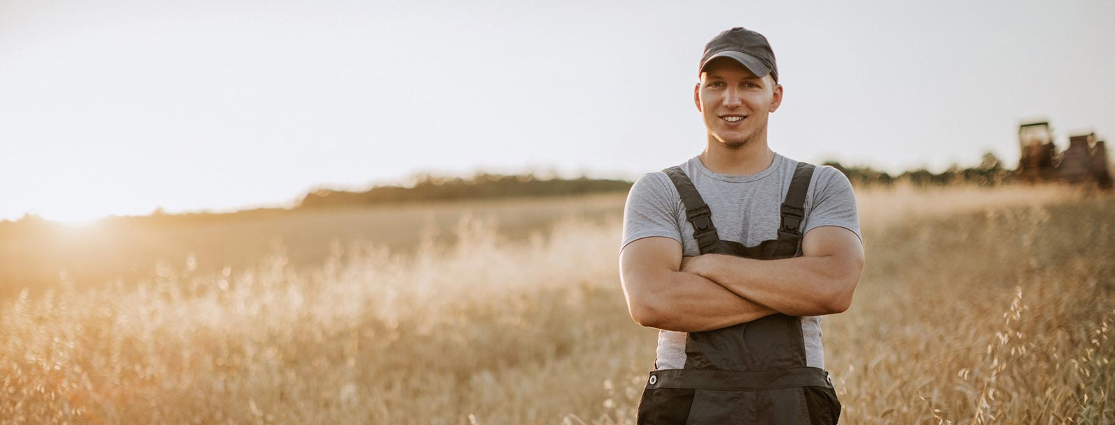 Farmer standing in wheat field.